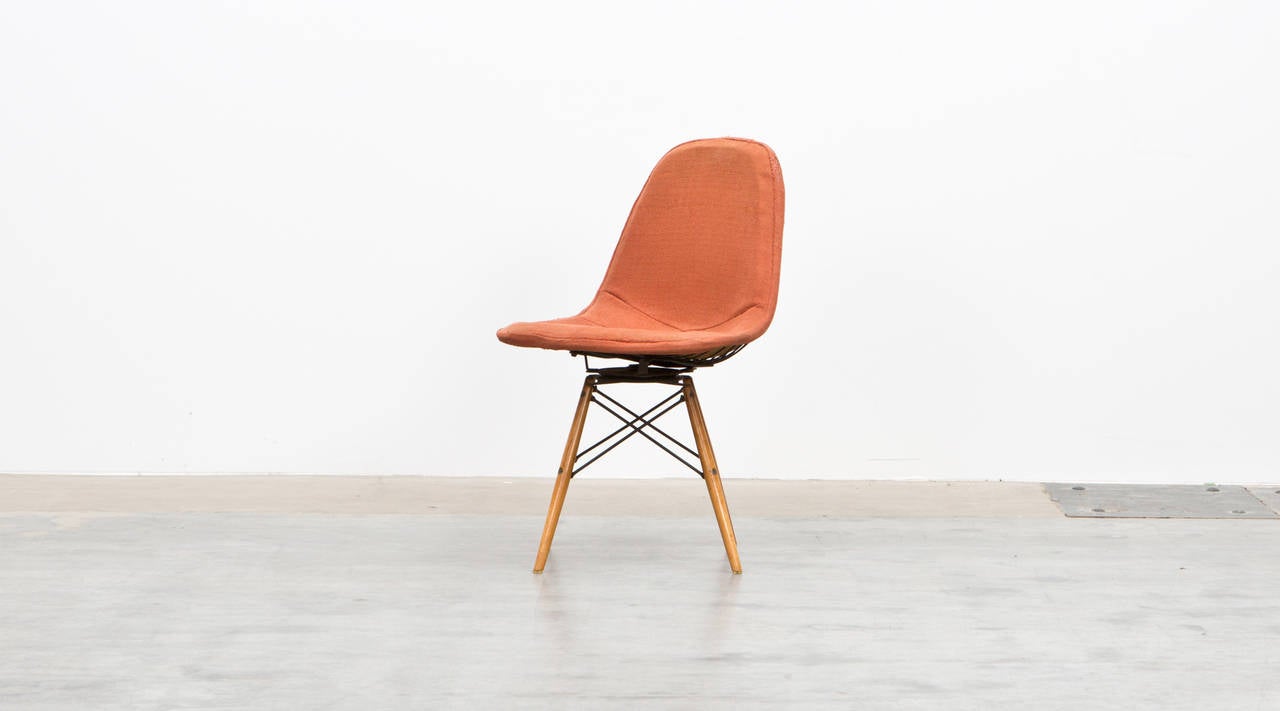 Original Swivel Chair by Charles & Ray Eames, USA, 1952

This early model designed by Charles and Ray Eames comes with a wooden dowel base and original fabric in orange on a black wire seat. Manufactured by Herman Miller.

Together with his wife Ray