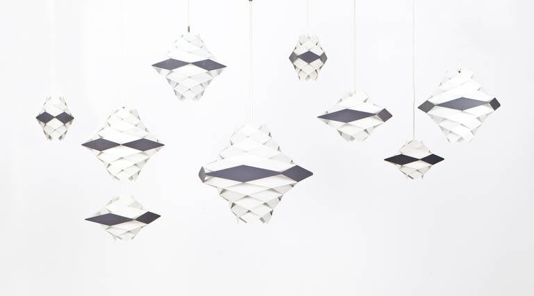 Set of nine Preben Dahl ceiling Lamps in lacquered metal from 1956. The different sizes and forms are linked through their diamond shape giving them an unique effect. Manufactured by Hans Følsgaard. 

Very little is known about the Danish light