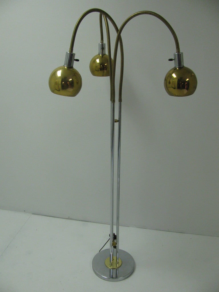 Unique and Diverse Mid Century Lamp with Three Individual Flexible Arms. Lamps Will Direct Light in All Direction. Brass and Nickel Chrome Combine To Create A Floor lamp From The Sixties With Style. Height and width adjustable.