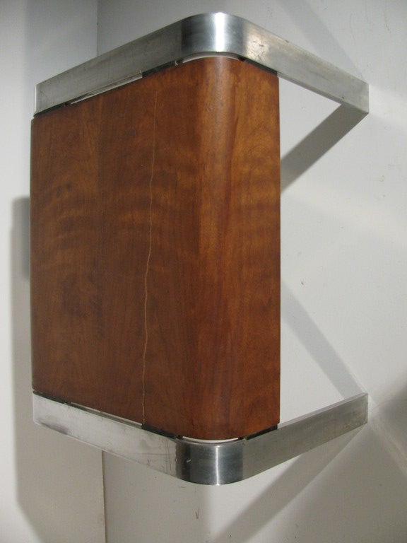 Rare side table in extruded aluminum and exotic wood.