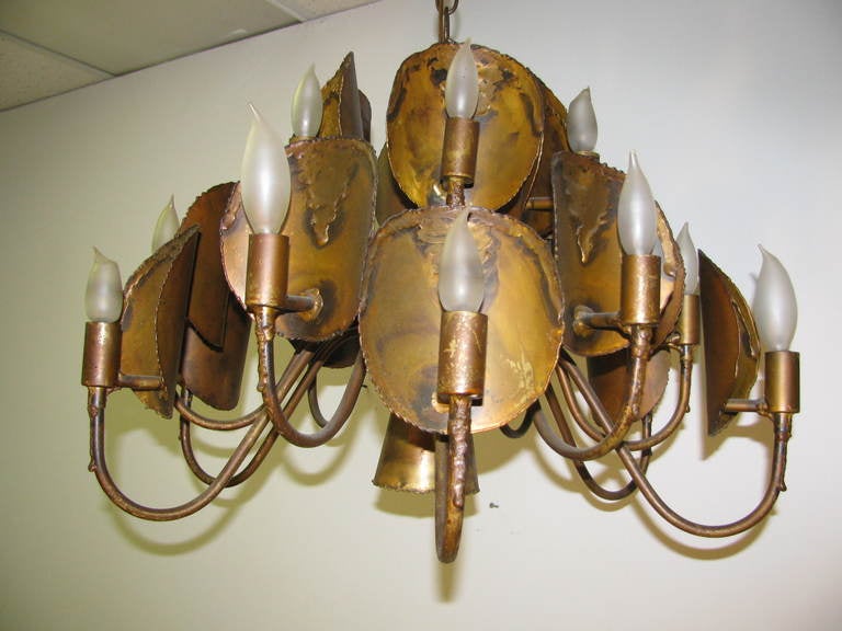 Vintage, elegant and simple Brutalist torch cut brass chandelier from the 1960s. Eighteen-light supply the illumination, along with center spot light. Excellent patina.