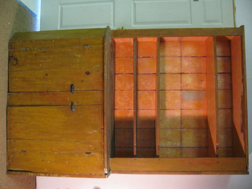 Large beautiful, primitive cupboard from an upstate New York farm house. Original mustard paint on wide pine boards. Four shelves for display and storage. Two doors with original locks on lower half. One piece cabinet. Height to step back shelf from
