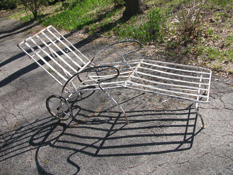 Pair of iron chaises with old black and white paint. Iron in excellent condition and they have been re-coated. Painted satin white.