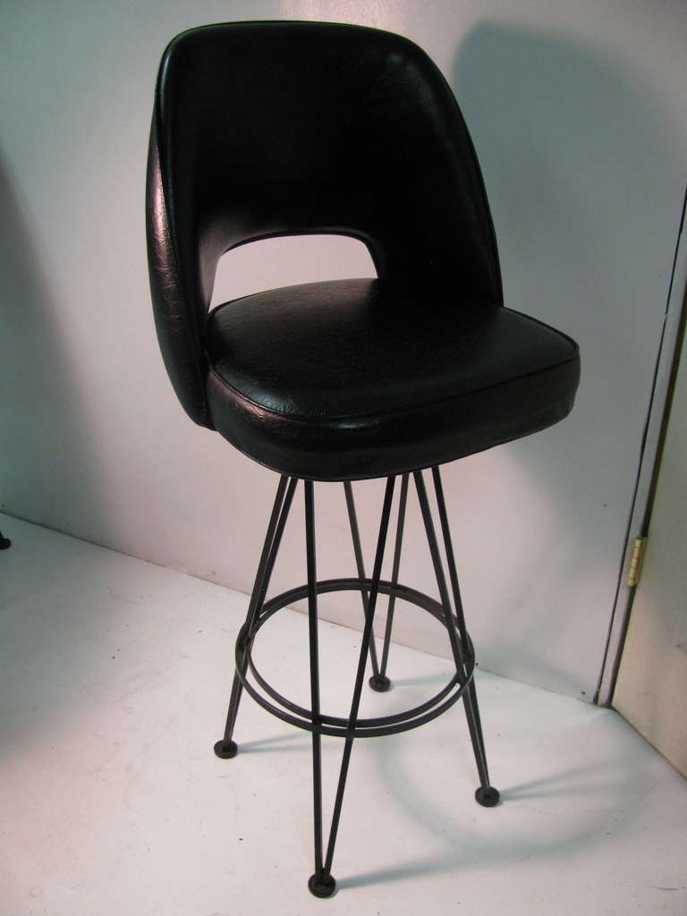 Unique bar stools in the manner of Eero Saarinen. Heavy iron bases support executive style seat which was designed by Saarinen circa 1952. All inquiries please call or just press contact dealer button.