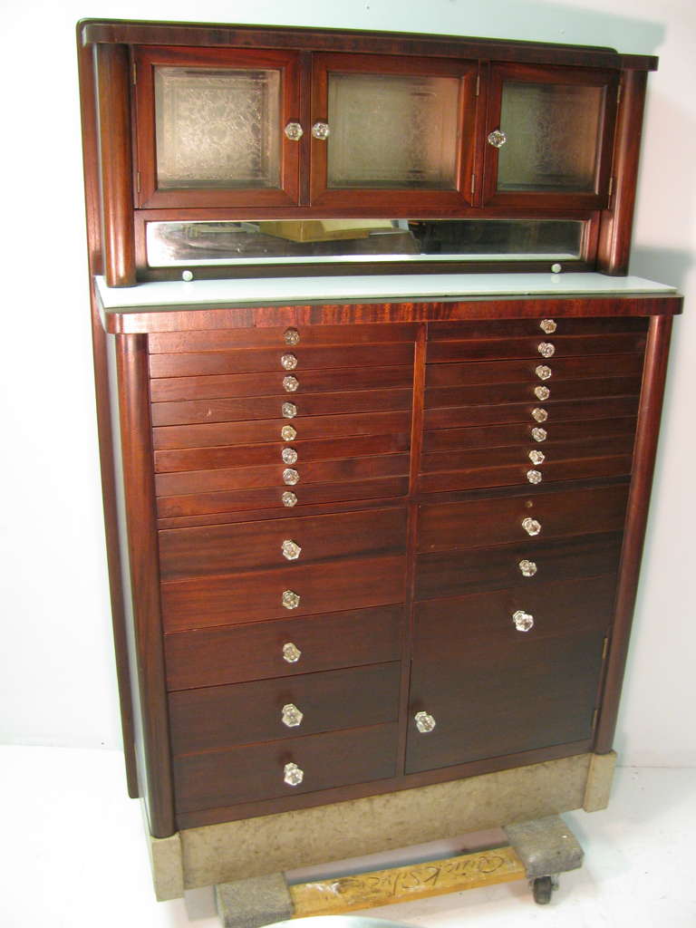Fabulous mahogany Victorian dental cabinet with marble base, etched glass doors and 25 drawers. Graduated glass pulls along with mirrored sliding door. Excellent storage cabinet for collections or the bath.  All inquiries please call or just press