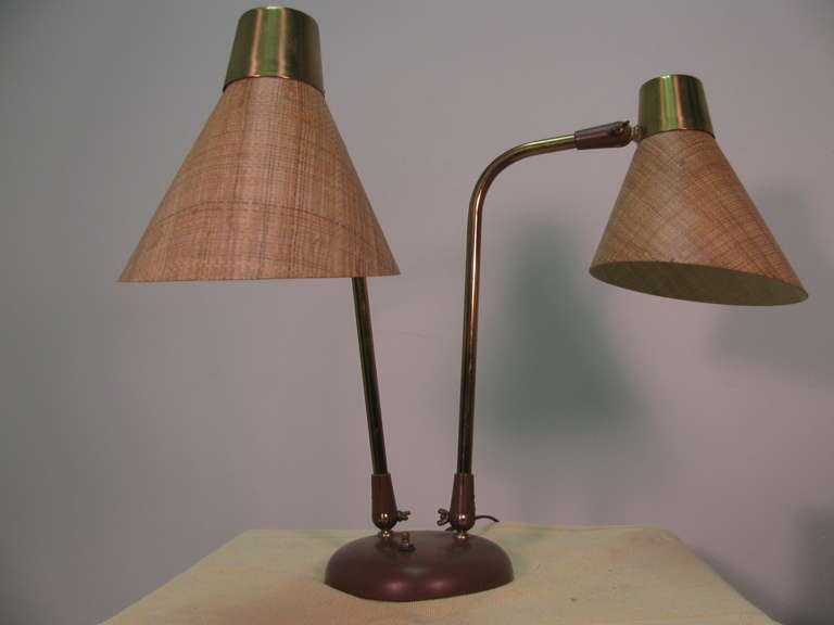 Beautiful and in amazing original condition. Lamps pivot a full 360 degrees and have adjustable shades created out of fiberglass. Locking hardware allows precise positioning of twin lamps. Three-way switch. This item can be parcel posted.