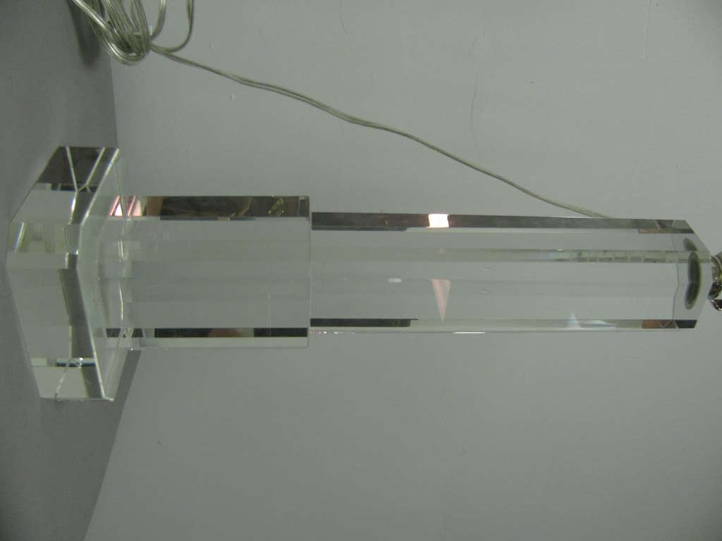 Amazing lead crystal glass lamp in the form of a Art Deco skyscraper. Classic design form which steps back as it rises. Amazing glass is solid and pure which looks to be one piece. All edges are beveled. Lamp is French wired.