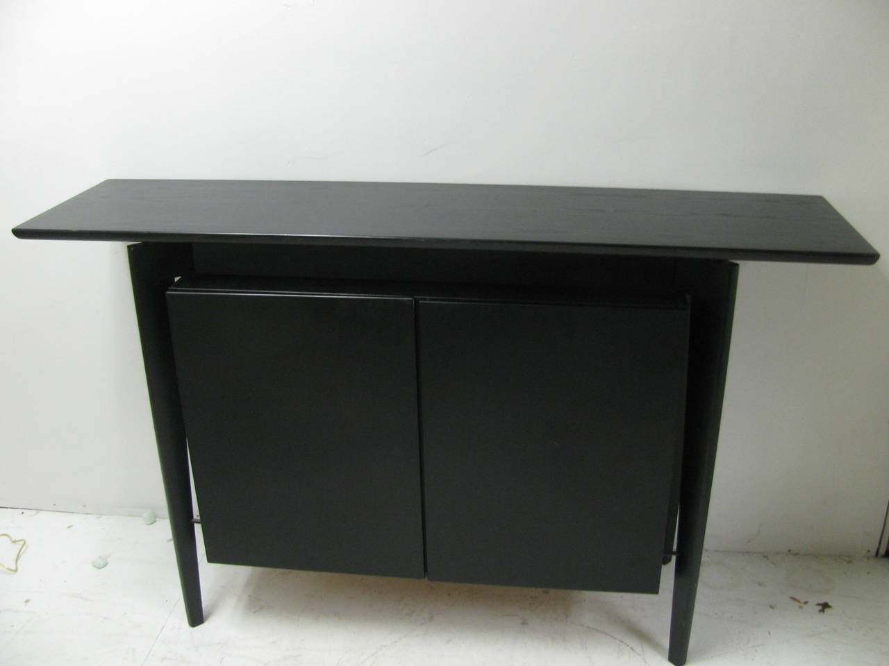 Simple and elegant sideboard or bar cabinet. Beautifully designed and well constructed by the Danish Co. Skovby. Ebonized oak with the cabinet floating between the legs. Two large drawers which open to reveal two drawers for some storage, possibly