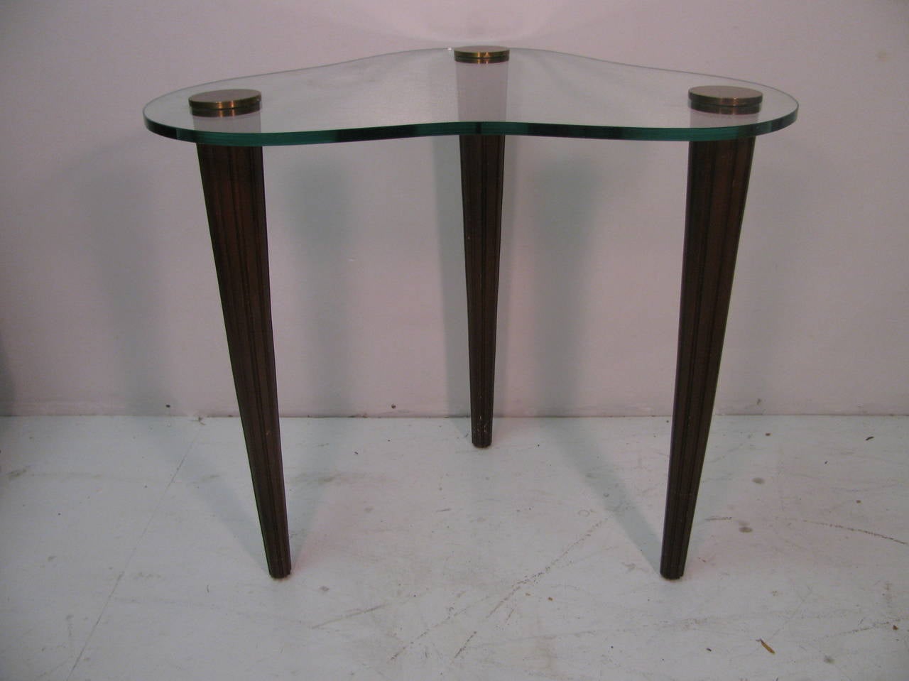 Fabulous pair of Art Deco glass top tables in the form kidney shape or of clouds. Tapered legs which are fluted and capped. Brass escutcheons that lock legs to the glass top.