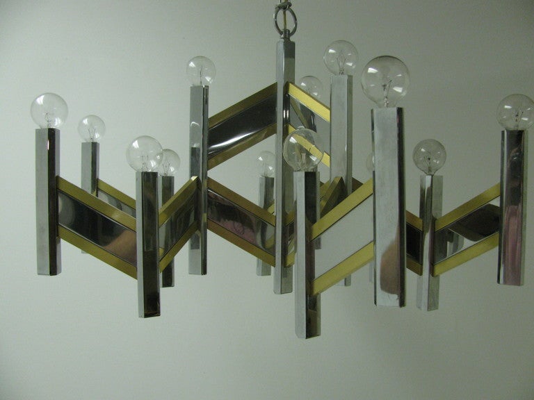 Mirror finish chrome with satin brass chandelier designed in a chevron zig zag pattern. Fifteen lights supply the illumination.

  
