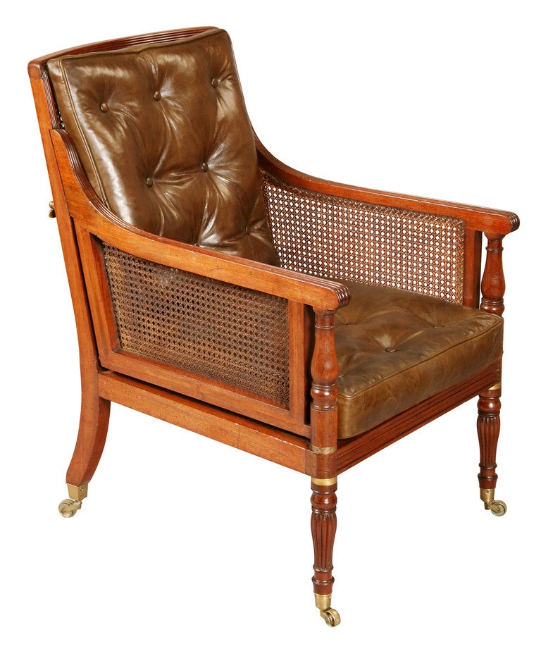 This mahogany Bergere Armchair breaks down for travel by unscrewing the legs and the bolts that hold the arms to the back. With the legs and back bolts removed, the arm panels will lift off. They are located to the back by a loose tenon joint to the
