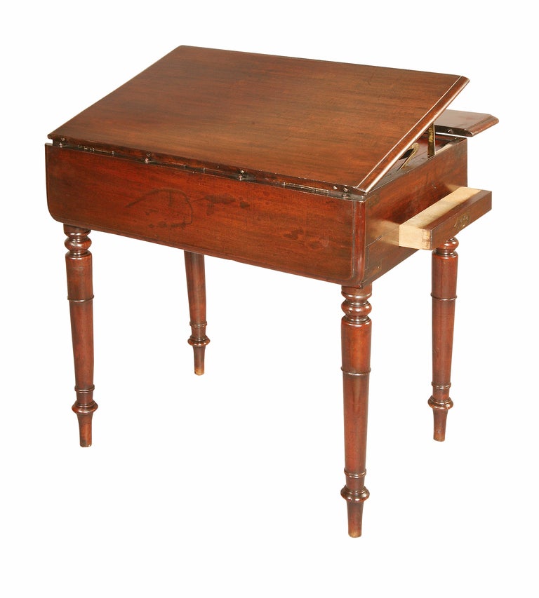 Known as a Ship Table, this mahogany Pembroke is dual purpose. The middle section of the top lifts up to reveal fittings for a wash bowl and 2 lift out metal dishes with 2 lidded compartments to the side. The front one has a removable tray with