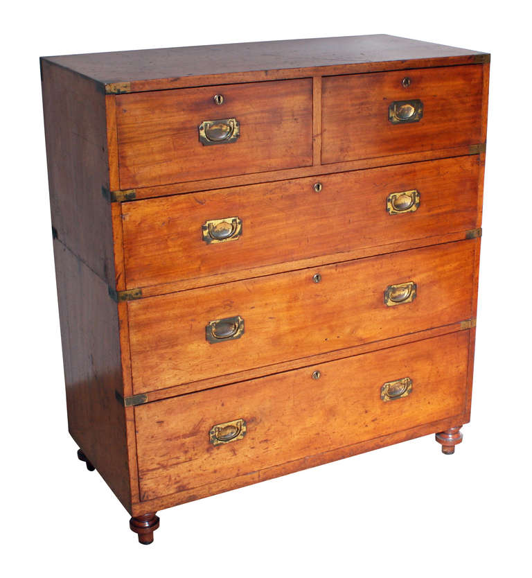 This mahogany Campaign Chest has two short over three long drawers and brass flush handles of a design that are typical of Ross & Co. It is brass bound with shaped corner brasses to the top. The maker’s pressed brass plague is inset to the top edge