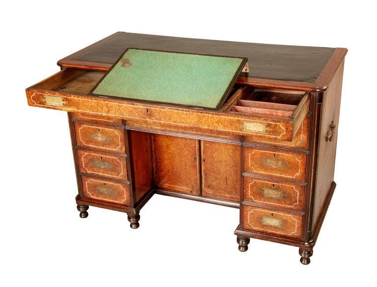 This Chinese Export Desk is made of amboyna offset against ebonised mahogany with ivory stringing. The side boards are huang huali wood and the top has a replaced black leather skiver with simple blind tooling. The thin top drawer has a green baized