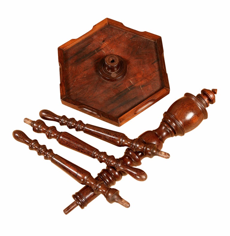 The top of this small Colonial campaign tripod table or candle stand is made of rosewood and the well turned column and legs, palm wood. The dark fibrous flecks of the grain of the palm wood on the dark brown background has a rich feel to it. All