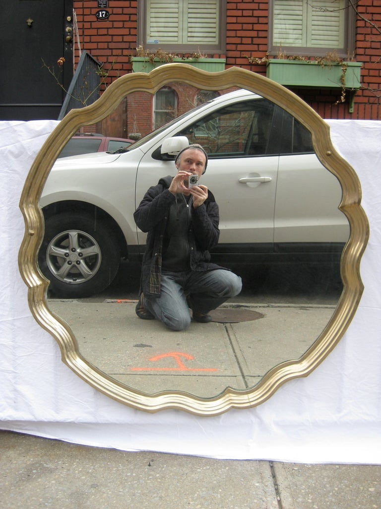 A mid-20th century brass scallop mirror.