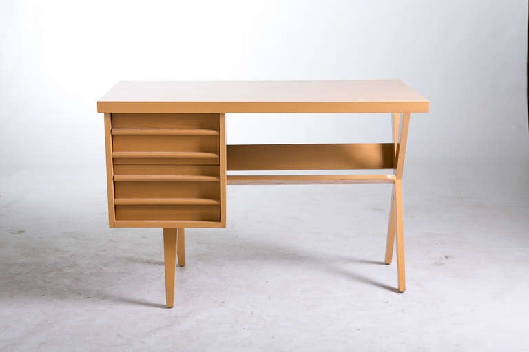 A 1950s mid-century desk with two drawers and a lower book rack. The desk has a blonde finish. The finish has been refreshed. 

Top Drawer: 12.5 inches wide x 18 inches deep x 5 inches high
Bottom Drawer: 12.5 inches wide x 18 inches deep x 6.4