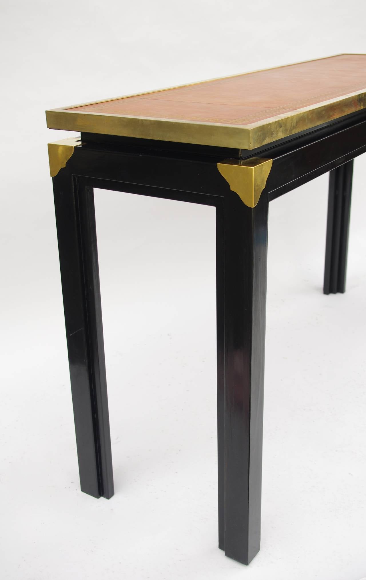 . Black lacquer metal
. Gilt brass
. Brown leather top
. 1970
