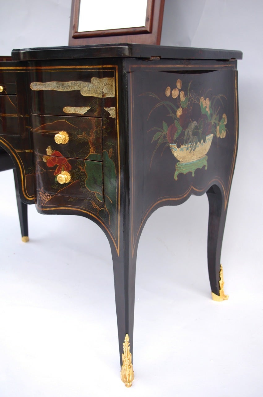 . Louis XV style
. Black lacquer decorated with mountain landscapes, scenes of palace and flowers
. Gilt bronze including handles buttons, feet and keyholes
. Opening with four drawers and leather-covered tablet hammered with small irons