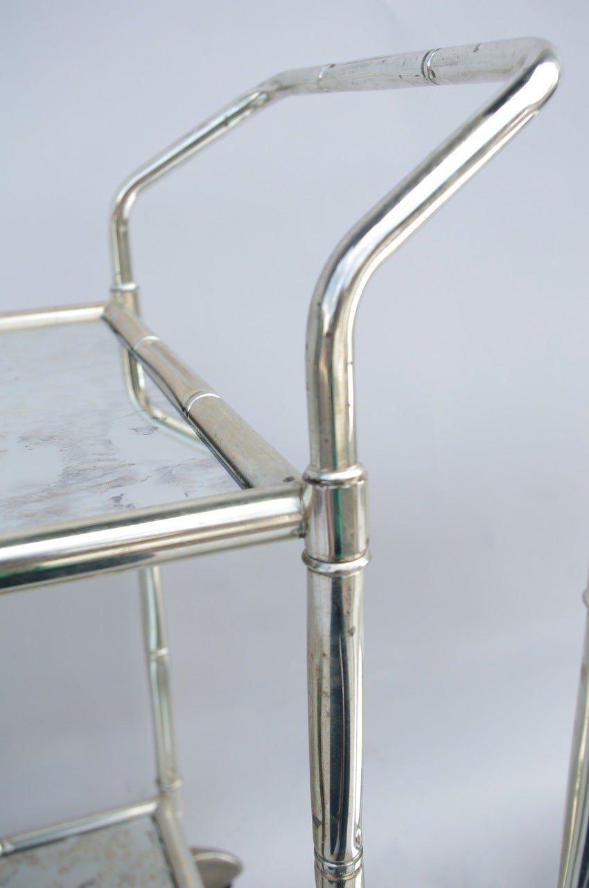 Silvered metal Bamboo style rolling trolleys with oxidized mirrors.
Made circa 1970.