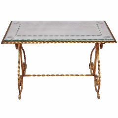 Gilt wrought iron coffee table with glass top, circa 1950