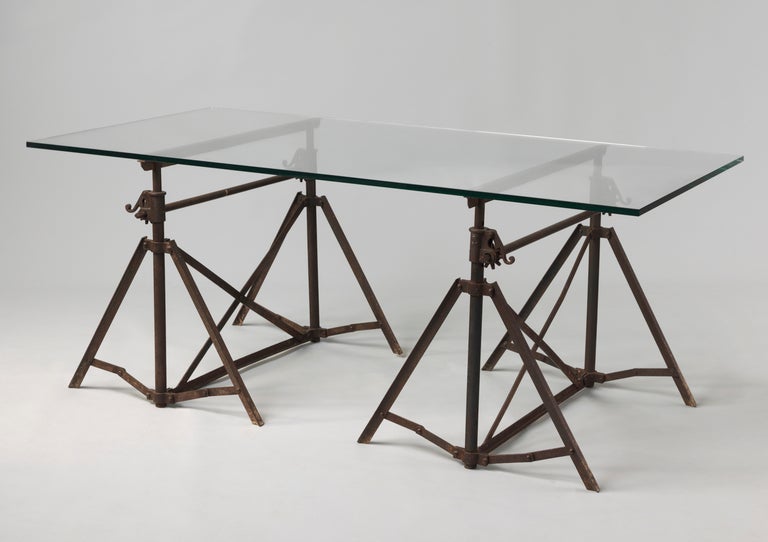 Now with a Contemporary Glass Top
Oxidised and Patinated Hand Wrought and Cast Iron
Probably French, c.1870
Glass = 78.75” wide x 39.75” deep
Trestles = Minimum 29.5” high , Maximum 50.25” high

A most unusual pair of Architect’s or