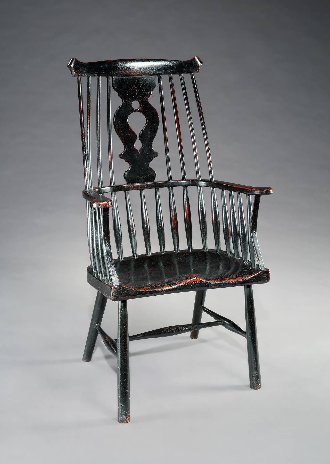 Generous comb and splat back Windsor armchair.
With well saddled seat and decoratively pierced splat.
Ash and elm with historic paint surface,
English, circa 1870.
