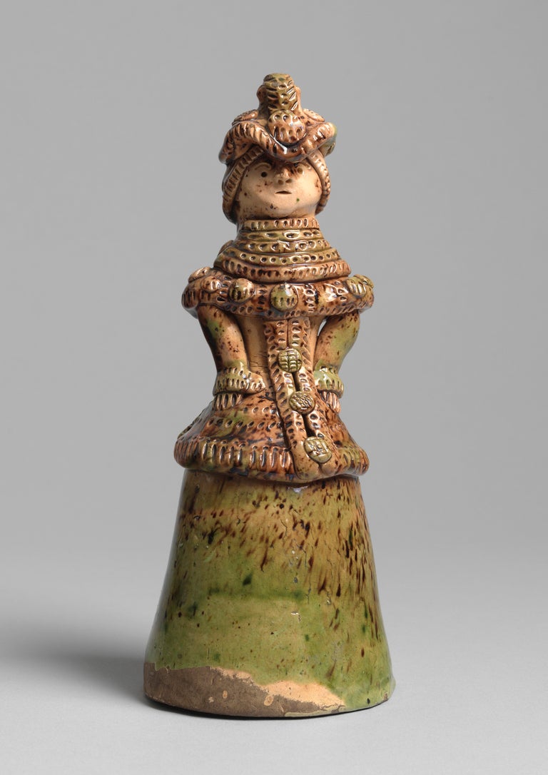 Of a Lady with bonnet and cape
'Art Populaire' glazed earthenware
French, probably Savoie region, circa 1880
Measures: 9.25