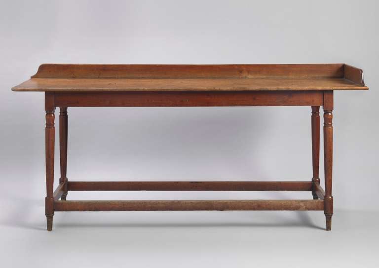 With Single Plank Part Galleried Faded Mahogany Top
Raised on Turned Legs Joined by Stretchers 
Solid Mahogany, Beech and Pine
English, C1830
35” high x 84 ½” long x 20 ½” deep

A slender English Country House serving table or hunt board.