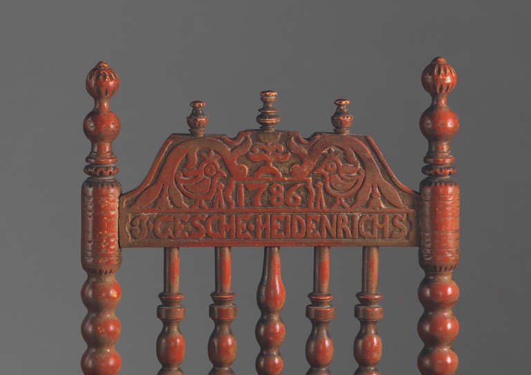 Carved and bobbin turned wood
with historic red on over original green painted surface.
Inscribed 'J. GESCHE HEIDENRICHS.'
Dated '1786.' 
Northern European.
Measures: 42.5" high x 24" wide x 15.5" deep.

A rare Turner’s open