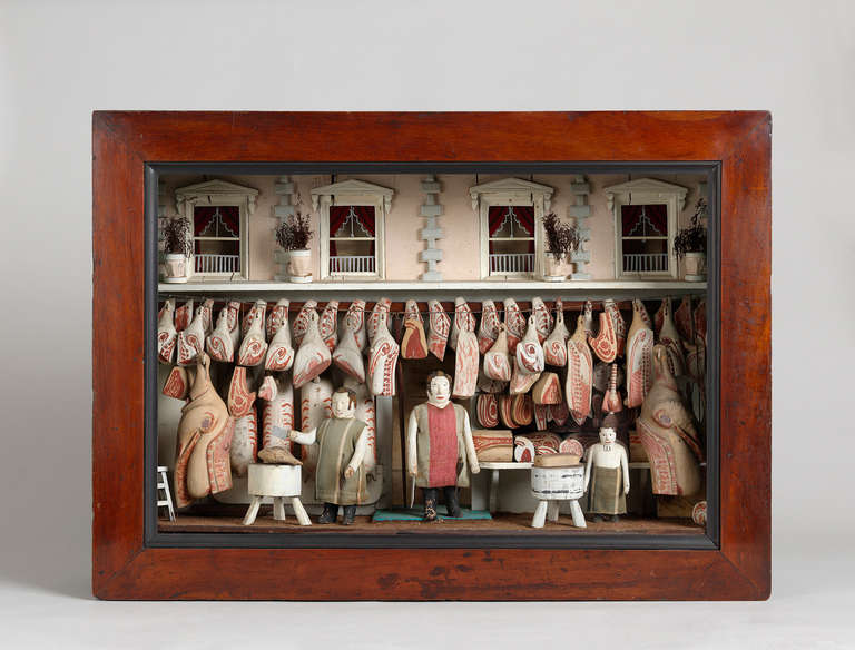 Hand Carved and Painted Wood and Various Media
Within Original Glazed Box Frame

These detailed model butcher's shops, were originally made to hang in a butcher's window when they were closed or the meat put away. Now incredibly rare such naive