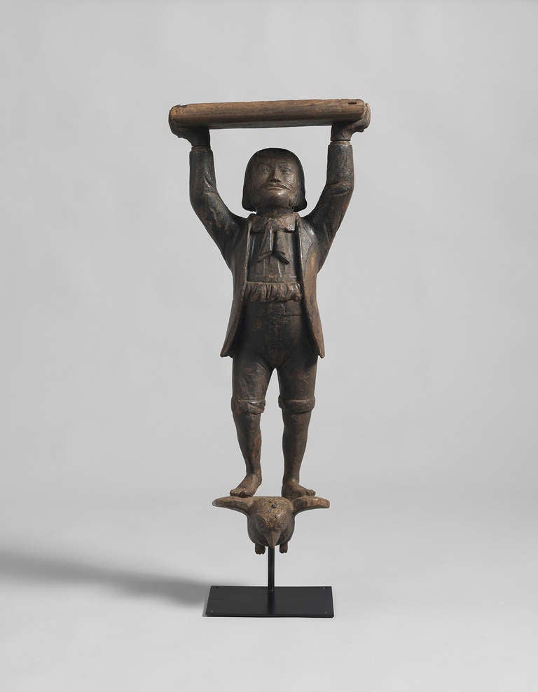 Holding a Tray Above his Head, Standing on the Outspread Wings of a Bird
Hand Carved and Painted Wood 

Provenance: English Private Collection, Wiltshire
