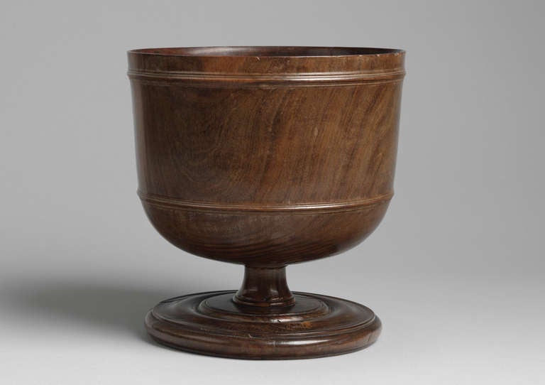 Solid Turned Lignum Vitae
With Fine Ring Turned Details
English, c.1660
9” high x 8.25” diameter

Wassail Bowls almost all date from 17th Century Britain. Generally turned from a single massive block of solid lignum vitae, because it could be