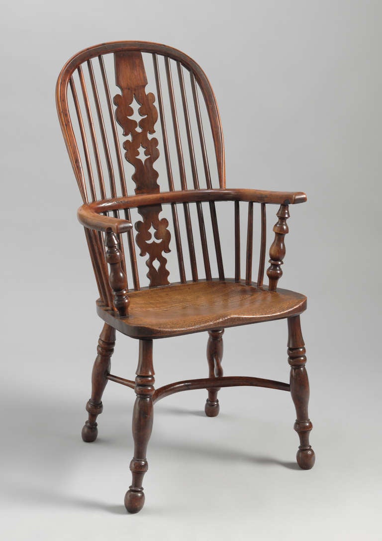 With decorative shaped and pierced splat and crinoline stretcher,
solid yew wood and elm,
English, circa 1840.
Measures: 46" high x 21.5" wide x 14.5" deep.

A Classic double bow high back Windsor armchair made from solid yew and