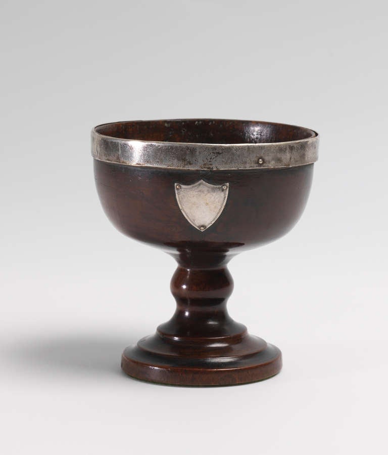 With Original Silver Metal Mounts 
English, c.1790 
8” high x 5” diameter 

Of classic form, with a turned baluster stem, this silver mounted goblet has excellent scale and proportions, the shield shaped cartouche is not inscribed and neither