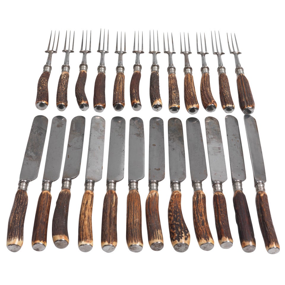 A Full Set of Twelve Stags Horn Handled Knives and Forks
