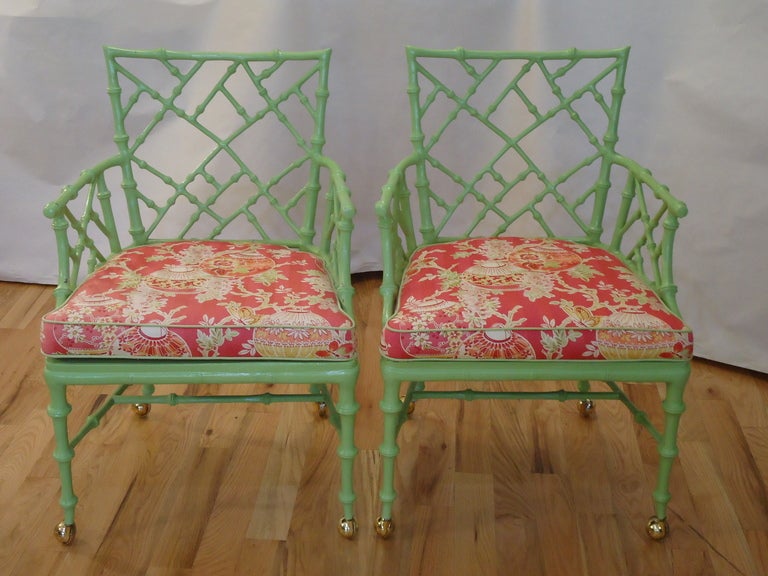 Pair of Chinese Chippendale Iron Bamboo Arm Chairs in apple green with beautiful Iron fretwork detail and brass castors.
Also available are 2 matching side chairs.