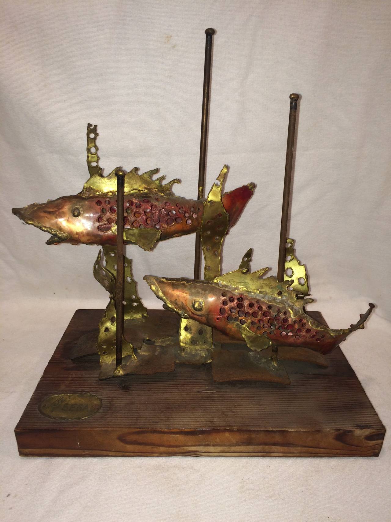 Signed Brutalist sculpture of fish by Segal. Incredible craftsmanship with attention to detail. Mounted on a piece of wood with a signed brass label. This item can parcel ship for $45.