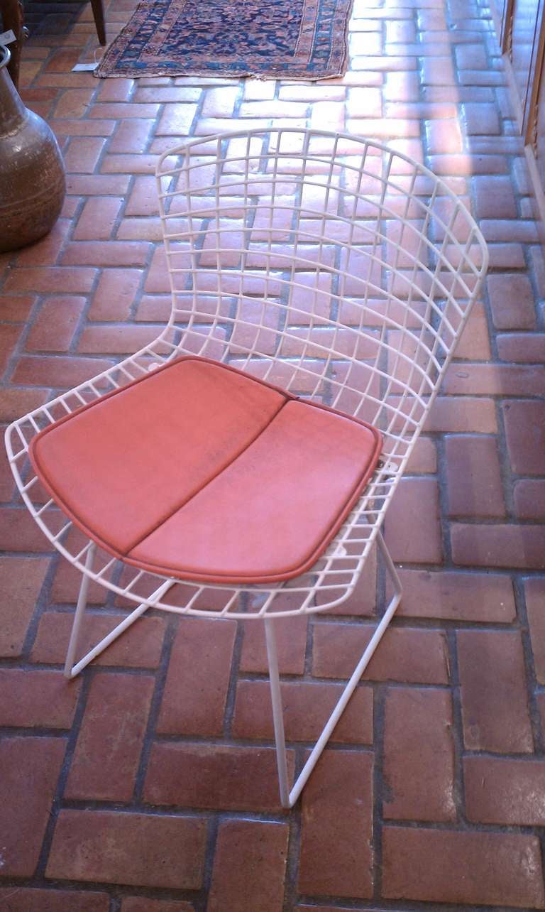 White Bertoia Chair With Orange Cushion