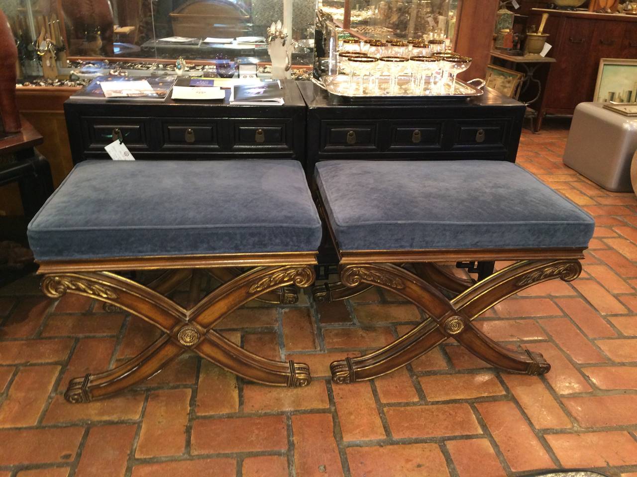 Pair of Ethan Allen French Regency X-base footstools. These stools have traditional styling with Classic design details. Blue gray velvet like upholstery top these stools.