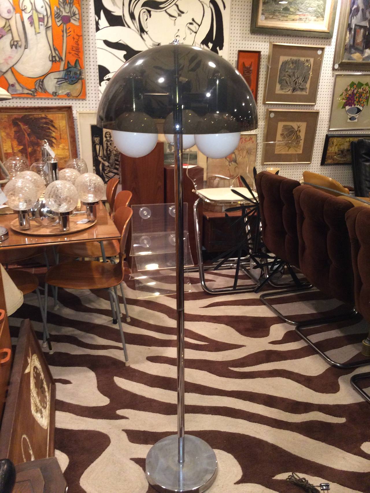 Smoked Lucite mushroom floor lamp in chrome. Bulbs can be changed to clear bulbs.  Classic tulip style shape with chrome base and three opaque white ball globes. One bulb is not lighting up . It may need a new bulb or repair to socket. Please ask