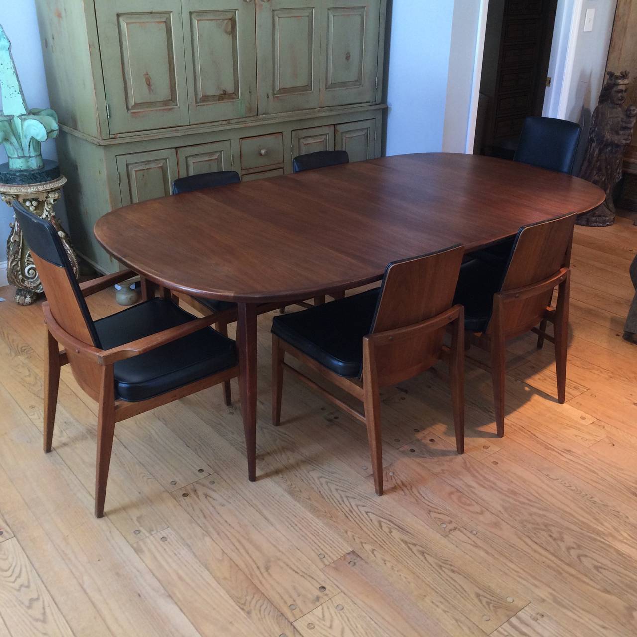 Mid-Century Modern walnut dining set by Foster McDavid. Founded in 1950 in Tampa, Florida Foster McDavid's designs exude the stylings of the mad men era. Great for dining or office. The seats are covered in black vinyl.