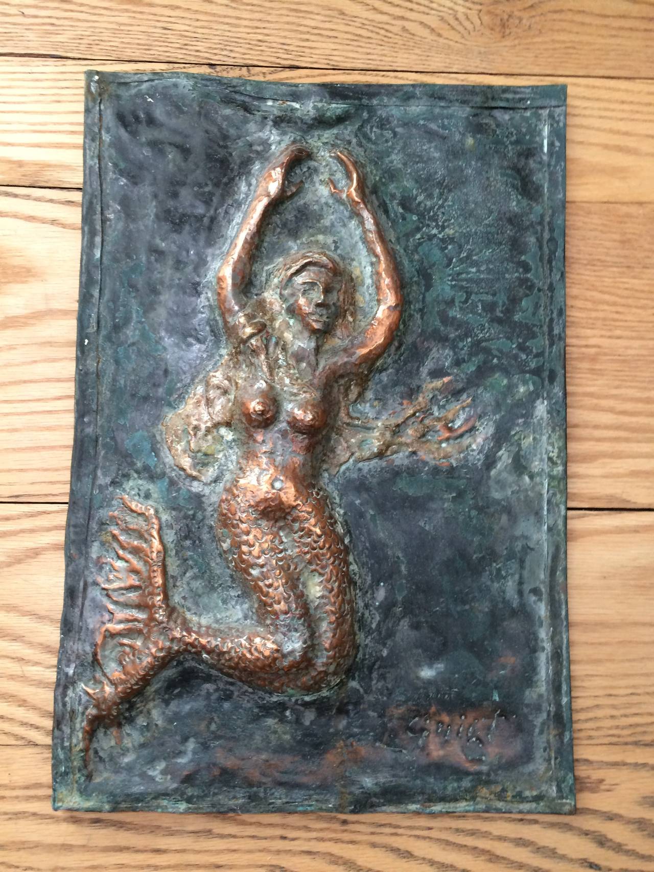Signed copper plaque of a mermaid. Lovely hand molded copper and bronze relief work of a Mermaid with long hair floating under water. Signed lower right. 
