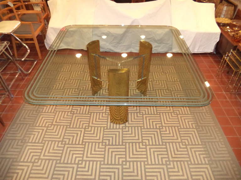 Milo Baughman style brass and glass dining table . Rare large square table which rests atop a tripod base consisting of Lucite and Brass. The large thick glass top has three impressive etched bands on its edge. Most likely Influenced by Charles