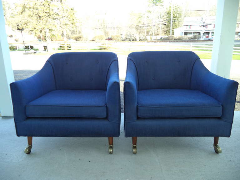 Pair of 1960's club chairs with castors. Indigo blue silk blend original upholstery.