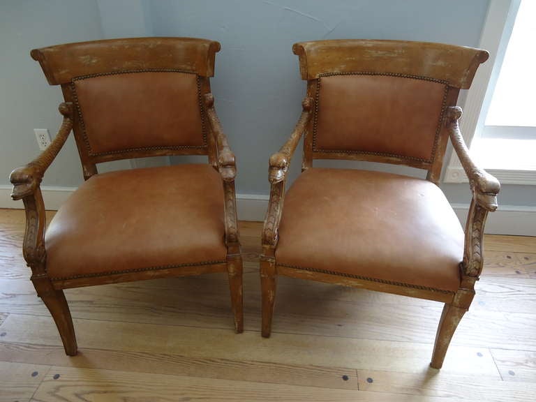These chairs by Meyer Gunther & Martini are highlighted by the intricately carved arms and high quality leather with a distressed/washed finish.