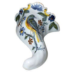 Antique English Delft ware wall pocket in polychrome with image of bird.