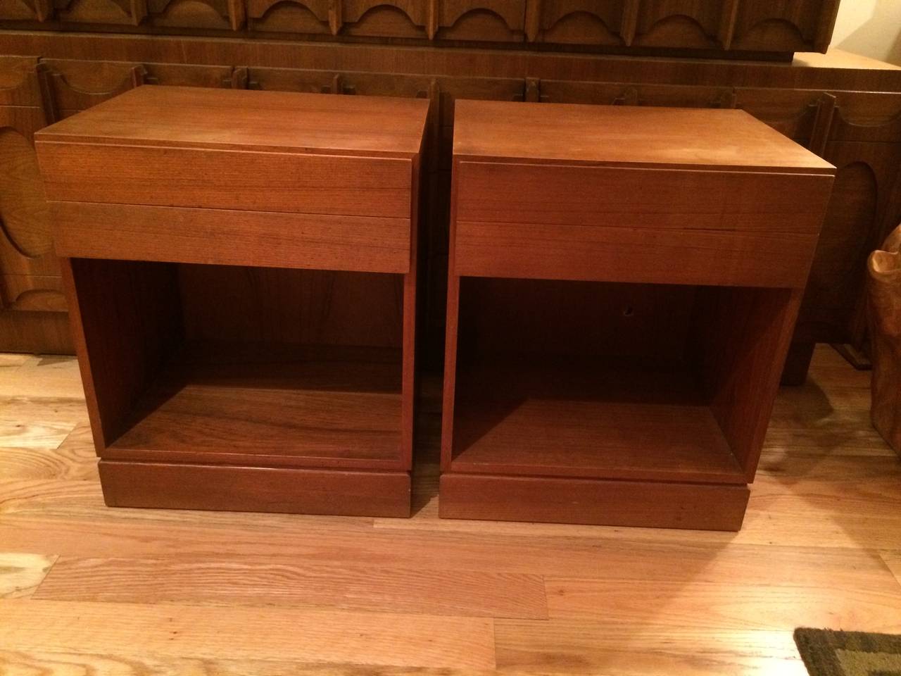 Pair of Danish Teak Nightstands. Signed Danish Makers. These stands have two thin sliced drawers and a cabinet base. Sleek minimal lines define these tables.
 The Danish Furnituremakers’ Quality Control (DFQC) stamp originated in 1959. It ensures