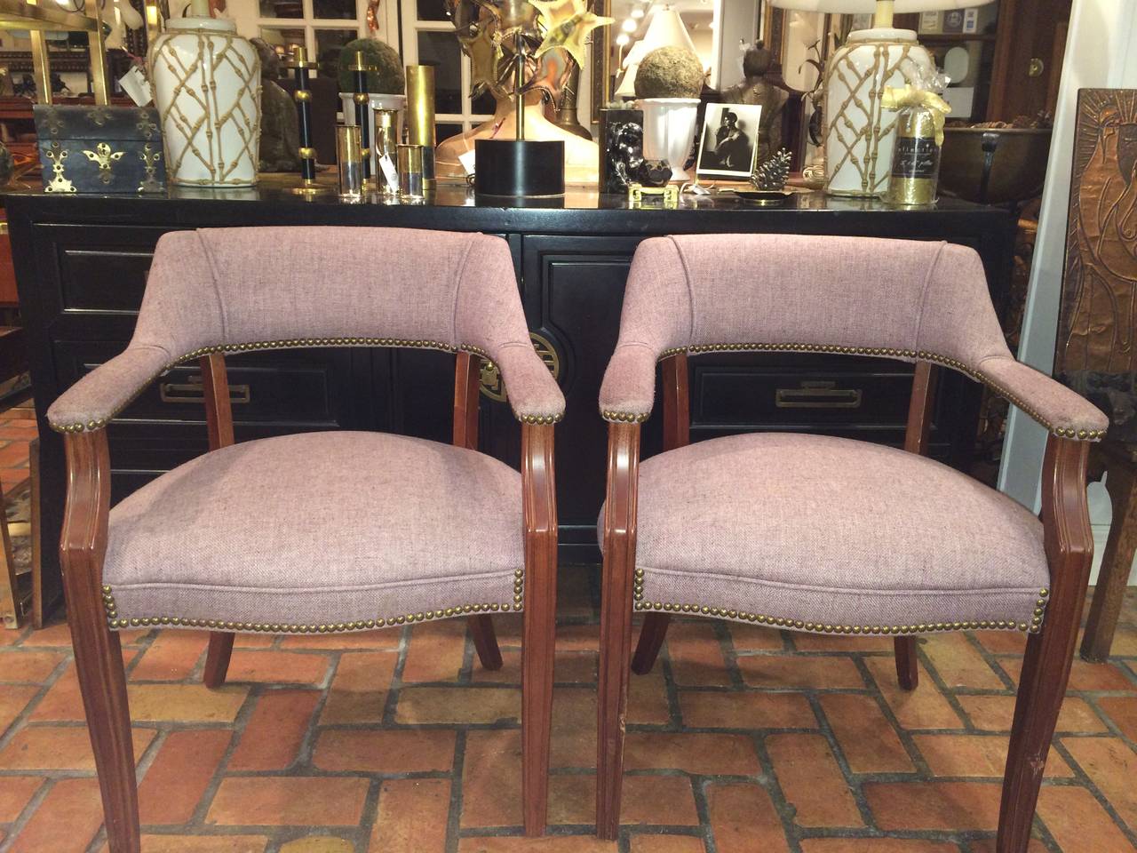 Pair of Mid-Century arm chairs. Original wool blend upholstery in a pale plum. Surrounded by brass studs. Attributed to Kimball.