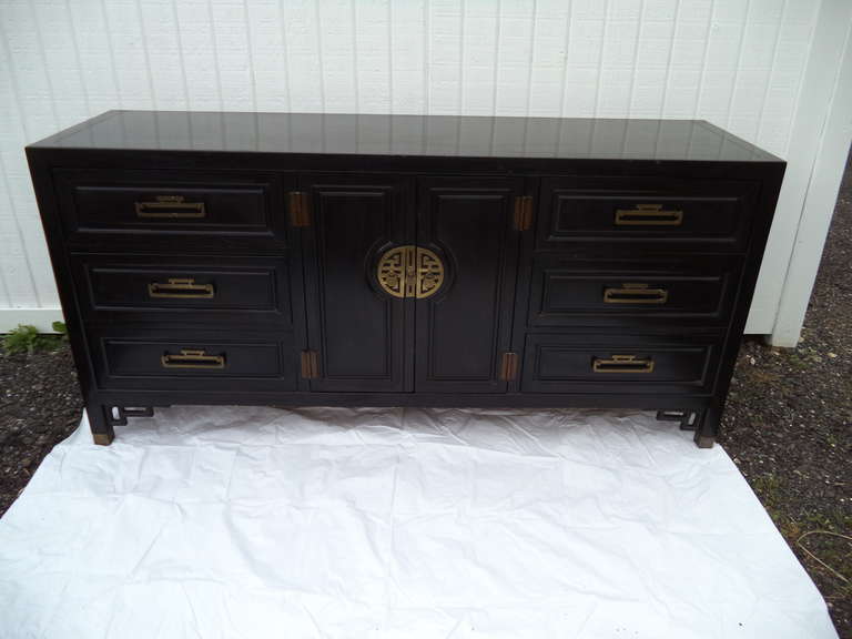 Black Chinese Chippendale Dresser/Credenza by Ray Sabota.
Highly stylized with Chunky Greek Key designed Brass hardware and faux bamboo style fretwork trim. Manufactured by Century Furniture. Matching pair of cabinets available.